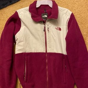 A maroon red and cream colored lg north faced jacket in excellent condition